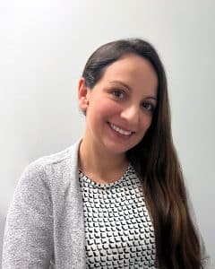 Woman in sweater blazer with long brown hair